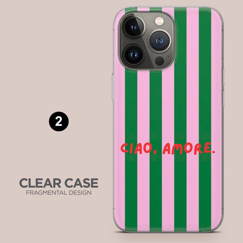 May include: Clear phone case with a vertical striped pattern in green and pink. The case features the text "CIAO, AMORE." in red. The case is labeled "CLEAR CASE FRAGMENTAL DESIGN".