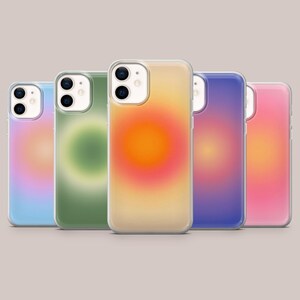 May include: Five mobile phone cases with gradient designs. The cases feature a variety of colours, including blue, green, yellow, orange, purple, and pink. Each case has a clear border and a camera cutout.