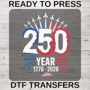 May include: A patriotic design featuring the number 250 in white, outlined in red and blue, with jets and the American flag. The text reads "YEAR 1776-2026" and "READY TO PRESS" and "DTF TRANSFERS" on a gray wood grain background.