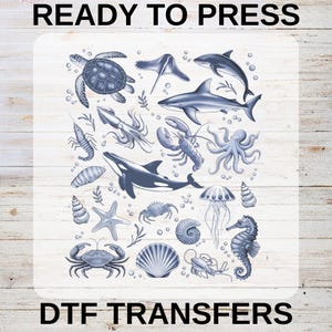 May include: DTF transfers featuring a variety of marine life illustrations, including a sea turtle, shark, octopus, and seahorse. The design is in shades of blue and gray, with the text "READY TO PRESS" and "DTF TRANSFERS".
