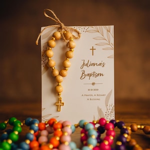 Natural baptism gift card, featuring a natural wooden rosary and gold cross charm, displayed on a soft and warm background. A Catholic baptism and first communion keepsake.