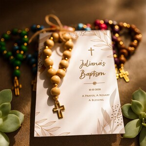 Natural baptism gift card, featuring a natural wooden rosary and gold cross charm, displayed on a soft and warm background. A Catholic baptism and first communion keepsake.