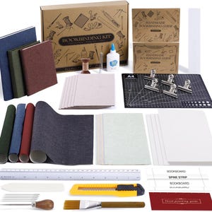 May include: A comprehensive bookbinding kit featuring a cardboard box labeled BOOKBINDING KIT, three bound books in blue, green, and red, a black A4 cutting mat, metal clips, white glue, a ruler, a yellow utility knife, needles, and paper.