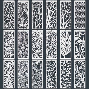 May include: A collection of eighteen rectangular white stencils featuring diverse laser-cut patterns including botanical leaves, floral arrangements, geometric shapes, and intricate swirling vines, each with a small hole at the top for hanging.