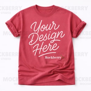 May include: A red t-shirt with rolled sleeves. The shirt displays the text "Your Design Here" in a white, cursive font. The word "Mockberry" is printed below the text in a smaller font.