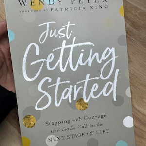 May include: A book cover with the title "Just Getting Started" in large white script. The cover is gray with colorful polka dots and gold foil accents. The author's name, Wendy Peter, and the foreword by Patricia King are also visible.