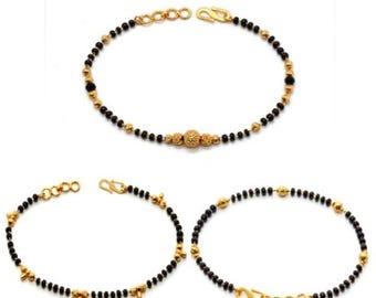 Pulsera de oro estilo mangalsutra con cuentas negras: joyería tradicional india minimalista.