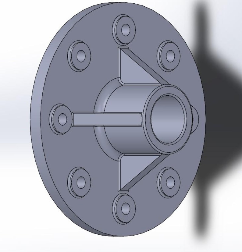 May include: A gray, circular mechanical component with a central cylindrical opening and six smaller circular openings around the perimeter. The component has a series of triangular and rectangular structural supports.