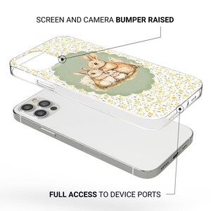 May include: Clear phone case with a floral pattern and a watercolor illustration of three rabbits. The case has the text "SCREEN AND CAMERA BUMPER RAISED" and "FULL ACCESS TO DEVICE PORTS".
