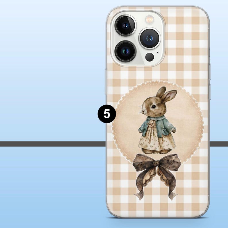 May include: A phone case featuring a tan and white gingham pattern. The case has a watercolor illustration of a bunny wearing a dress and jacket. A brown bow is at the bottom of the design. The number 5 is in a black circle.