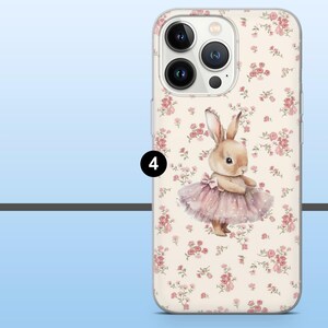May include: A clear phone case featuring a watercolor illustration of a bunny wearing a pink tutu. The case has a floral pattern of pink roses on a cream background. The phone's camera lenses are visible.