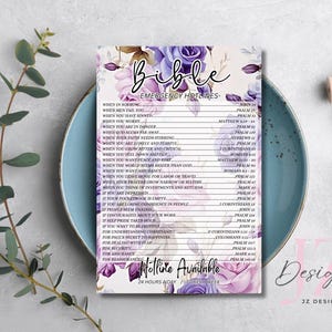 May include: A floral-themed Bible emergency hotline print, featuring a list of verses for various situations. The design includes purple and white flowers, with the text "Bible Emergency Hotlines" at the top. The print is displayed on a blue plate.