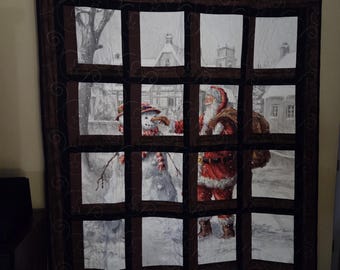 Santa thru the Window Quilted Wall Hanging or Throw.  Cozy up or show it off.  it measures 51 X 58.  Quilted in a swirling star pattern.