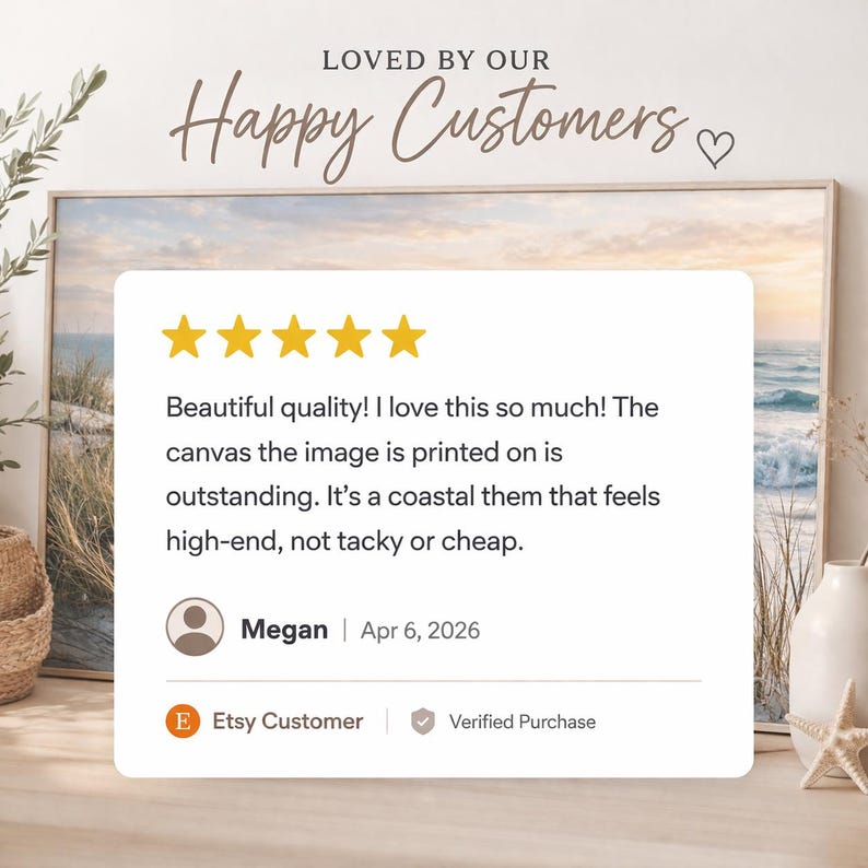 The image is a framed photograph of a coastal scene, with a starfish and a vase of flowers on a table. The text in the image reads "LOVED BY OUR Happy Customers" and "Megan | Apr 6, 2026", indicating that the image is a review of the artwork.