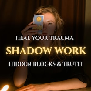 May include: A person holding a tarot card in front of their face, with the words "HEAL YOUR TRAUMA," "SHADOW WORK," and "HIDDEN BLOCKS & TRUTH" in white and gold lettering. The background is dark.