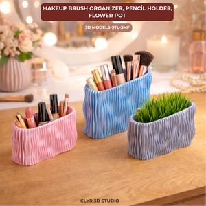 May include: Three decorative containers in pink, blue, and gray, each with a wavy texture. The pink container holds lipsticks and makeup, the blue one holds makeup brushes, and the gray one contains green grass. The text at the top says "MAKEUP BRUSH ORGANIZER, PENCIL HOLDER, FLOWER POT."