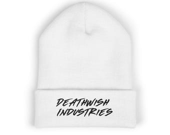 May include: White beanie with the text "DEATHWISH INDUSTRIES" in black, centered on the folded brim. The beanie is made of a soft, knitted material. The background is white.
