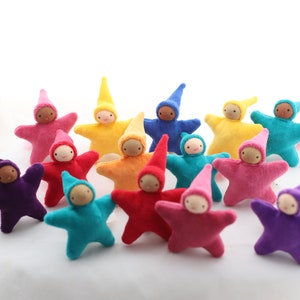 May include: A collection of 14 handmade felt star-shaped dolls with pointed hats in various colors, including purple, pink, red, orange, yellow, green, blue, and turquoise.