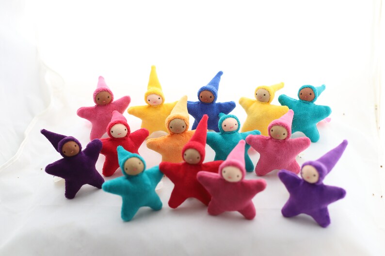 May include: A collection of 14 handmade felt star-shaped dolls with pointed hats in various colors, including purple, pink, red, orange, yellow, green, blue, and turquoise.