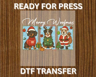 May include: A DTF transfer featuring three dogs dressed for Christmas. The dogs are wearing Santa hats, reindeer antlers, and Christmas sweaters. The text "Merry Woofmas" is written above the dogs, and "READY FOR PRESS" and "DTF TRANSFER" are written above and below the image.