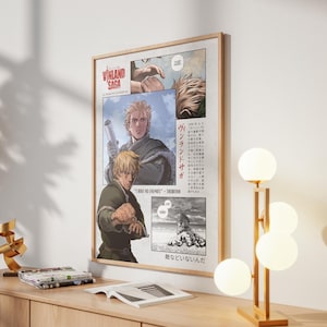 May include: A framed poster featuring artwork from the manga series "Vinland Saga." The poster has a light wood frame and displays panels of illustrations with characters and Japanese text. The color palette includes shades of blonde, green, and gray.