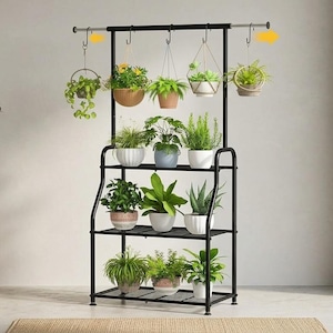 May include: A black metal plant stand with three shelves and a hanging rod. The stand holds various potted plants, including hanging baskets. The plants are in different sizes and colors, creating a vibrant display. The stand is placed indoors near a window.