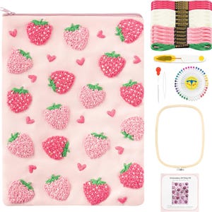 May include: A pink embroidery DIY bag kit featuring a strawberry design. The kit includes embroidery floss in shades of pink and green, a needle, a threader, a pin wheel, a wooden hoop, and a small instruction sheet.