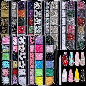 May include: A collection of nail art supplies, including rhinestones, glitter, and flower-shaped embellishments, organized in clear plastic containers. Also included are tweezers, a pencil, and several decorated nail tips with various designs and colors.