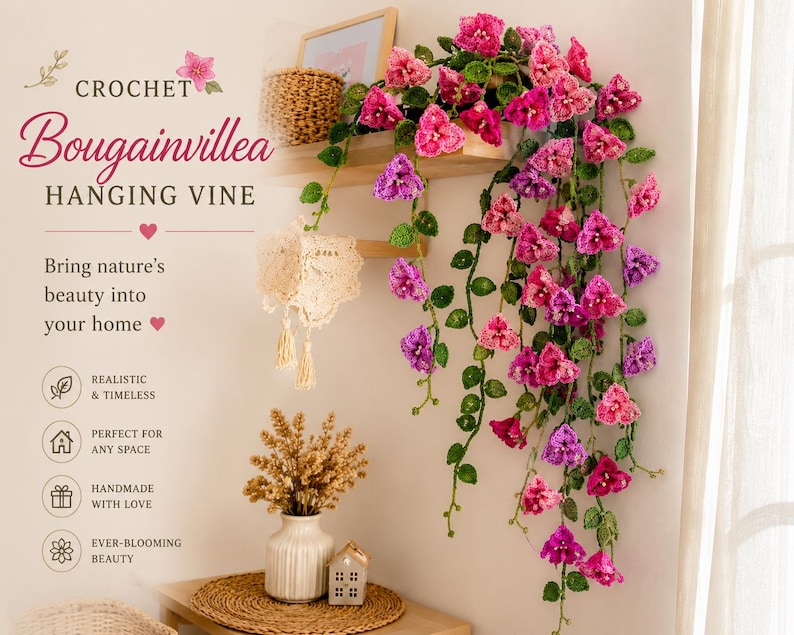May include: Crochet bougainvillea hanging vine in shades of pink and purple. The handmade floral arrangement includes green leaves and is displayed on a wooden shelf. The text reads "Bring nature's beauty into your home."