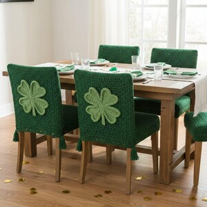 May include: A dining room set with six chairs, each adorned with a green crocheted cover. The chair backs feature a large, light green shamrock applique. The wooden table is set with plates and glasses, and the floor is scattered with gold shamrock confetti.