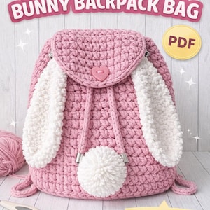 May include: A pink crochet bunny backpack bag with white fluffy ears and a pom-pom tail. The bag has a heart-shaped button closure and a drawstring. The text "CROCHET PATTERN BUNNY BACKPACK BAG" is displayed at the top.
