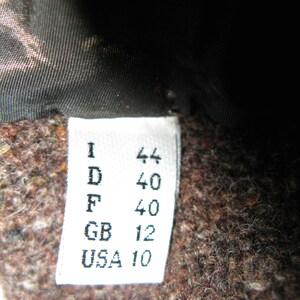 May include: White tag with black text indicating sizes in different countries: I 44, D 40, F 40, GB 12, USA 10.