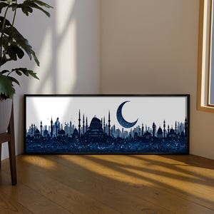 May include: Framed art print featuring a silhouette of a city skyline with mosques and minarets in shades of blue. A crescent moon with a starry texture is in the upper right. The artwork is in a black frame.