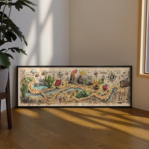 May include: A rectangular framed wall art piece featuring a detailed, hand-drawn style map on a light tan background. The illustration depicts a winding path through a landscape with cacti, a volcano, a compass rose, and a small ship.