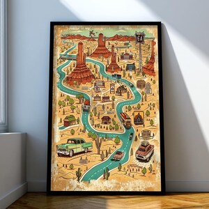 Op de afbeelding: Een ingelijste verticale poster met een gestileerde kaart van een woestijnlandschap met een kronkelende turquoise weg, rode rotsformaties, cactussen en oldtimers. De illustratie bevat een bord met het opschrift Route 6A en gebouwen.