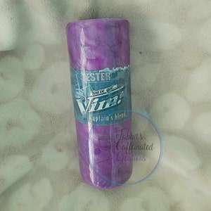 May include: Purple and blue stainless steel tumbler with a white and blue label that says "You've got... Vim! Captain's Blend".