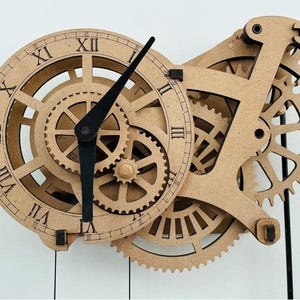 May include: A wooden clock with visible gears and Roman numeral hour markers. The clock features a circular face with black hands and a complex gear mechanism. The clock is made of light brown wood and hangs from black rods.