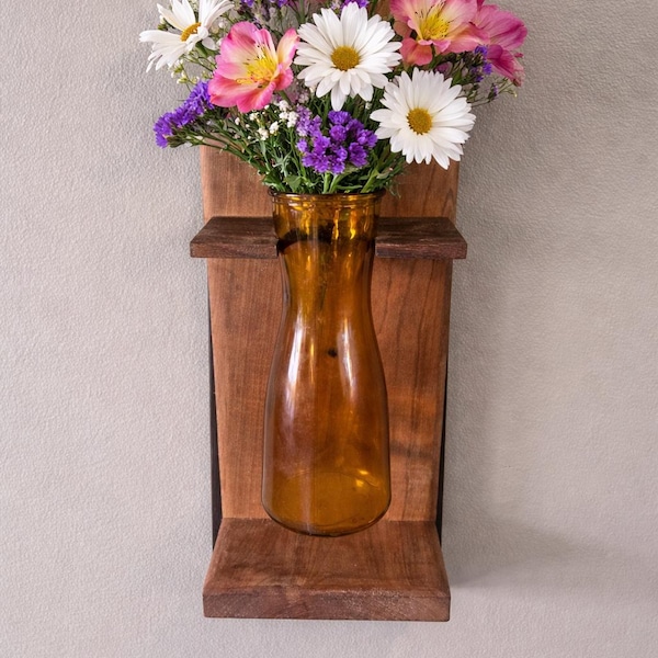 Handcrafted wooden wall hanging with glass vase