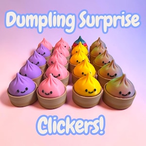 May include: A collection of colorful dumpling-shaped clickers in shades of purple, pink, yellow, and rainbow. Each clicker has a smiling face and sits in a brown container. The text "Dumpling Surprise Clickers!" is displayed above and below the clickers.