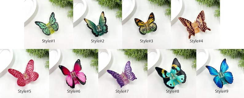 May include: A collection of nine butterfly-shaped decorative objects, each with a unique color scheme and design. The butterflies are labeled with the text "Style#" followed by a number from 1 to 9. The colors include green, blue, yellow, red, and purple.