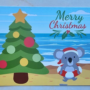 Cartolina di Buon Natale Koala sulla spiaggia
