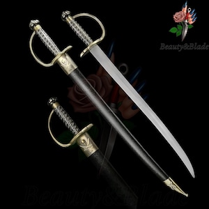 May include: A decorative pirate sword with a curved blade. The hilt features a skull and crossbones design, with a silver and gold finish. The sword is sheathed in a black scabbard. The text "Beauty&Blade" is visible.