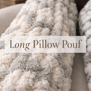 May include: A long, textured pillow pouf in shades of cream, gray, and white. The image shows a close-up of the soft, chunky knit fabric. The text "Long Pillow Pouf" is displayed across the center of the image.