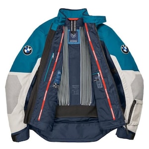 May include: Teal and white motorcycle jacket with the BMW logo on the sleeves. The jacket has a zip-up front, multiple pockets, and a mesh lining. The interior features a striped pattern and red accents. The jacket is designed for protection and style.