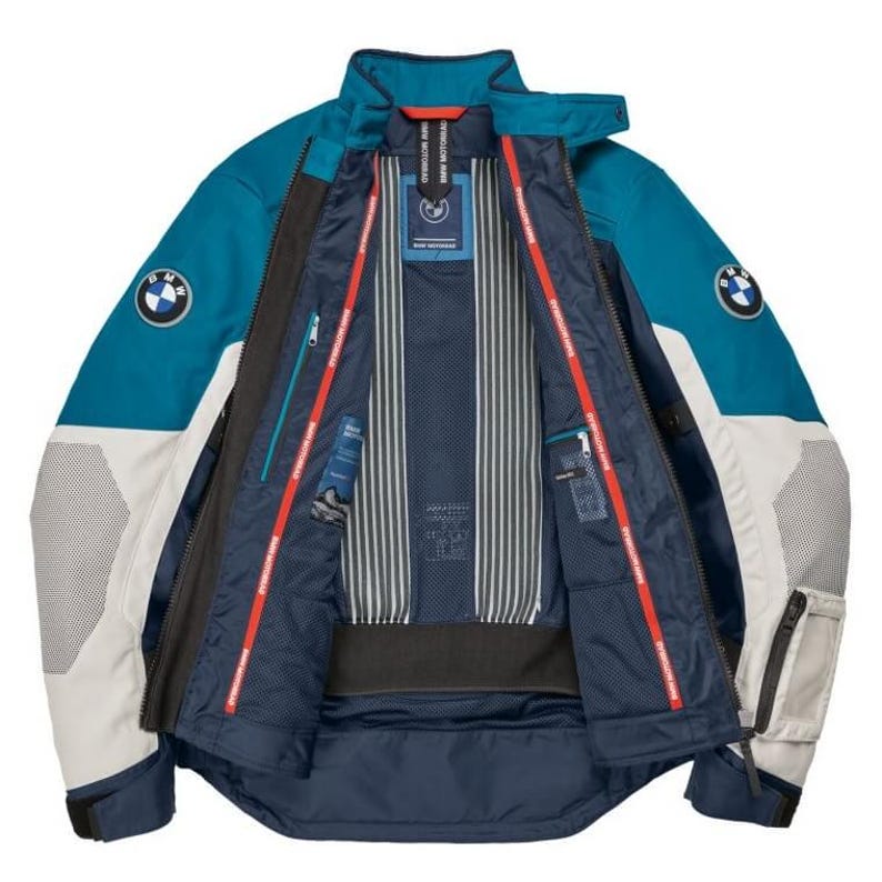May include: Teal and white motorcycle jacket with the BMW logo on the sleeves. The jacket has a zip-up front, multiple pockets, and a mesh lining. The interior features a striped pattern and red accents. The jacket is designed for protection and style.