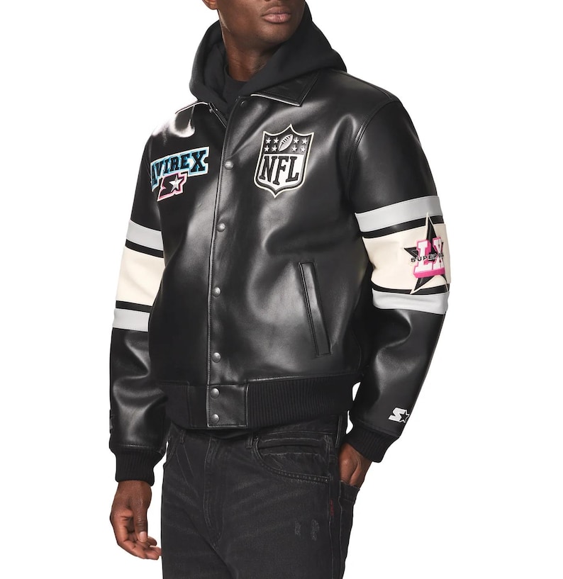 May include: Black leather jacket with a button-up front, featuring patches with the NFL logo, the word "AVIREX", and a star design. The jacket has white and gray stripes on the sleeves and a black ribbed collar and cuffs.