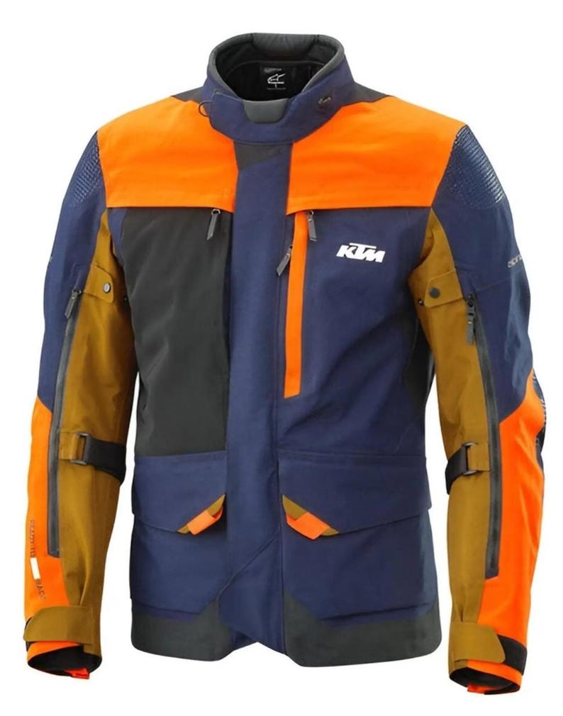 Puede incluir: Chaqueta de moto multicolor con paneles naranjas, azul marino, negros y beige. La chaqueta tiene m&uacute;ltiples bolsillos, cremalleras y el logotipo de KTM en el pecho. Tiene un cuello alto y est&aacute; dise&ntilde;ada para la protecci&oacute;n y la visibilidad.
