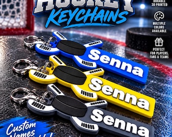 May include: Three 3D printed hockey stick keychains with a black puck center, each featuring the name Senna in white lettering. The keychains are blue, yellow, and grey, and each includes a silver metal lobster clasp attachment.