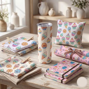 May include: A collection of dessert-themed items, including a tumbler, napkins, a pillow, wrapping paper, and notebooks. The items feature a repeating pattern of ice cream cones, cupcakes, and cookies in pastel colors on a cream background.