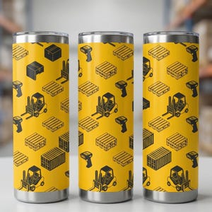 May include: Three stainless steel insulated tumblers with a yellow background and a repeating pattern of black forklifts, pallets, boxes, and barcode scanners. The tumblers have a silver rim and base.